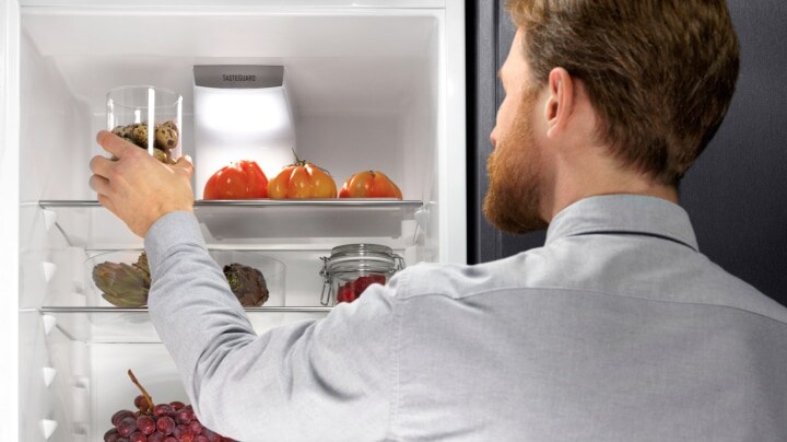 A man opening a refrigerator